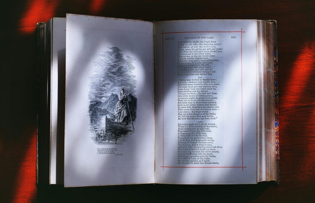 An open vintage book displaying illustrated poetry pages, creating an artistic literary ambiance.